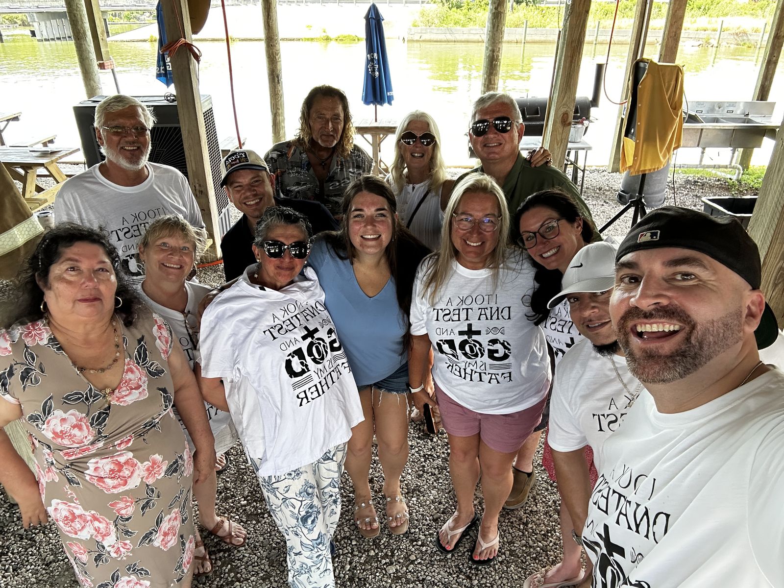 The Lighthouse Community family gathered under Sammy G&rsquo;s, with the water behind them