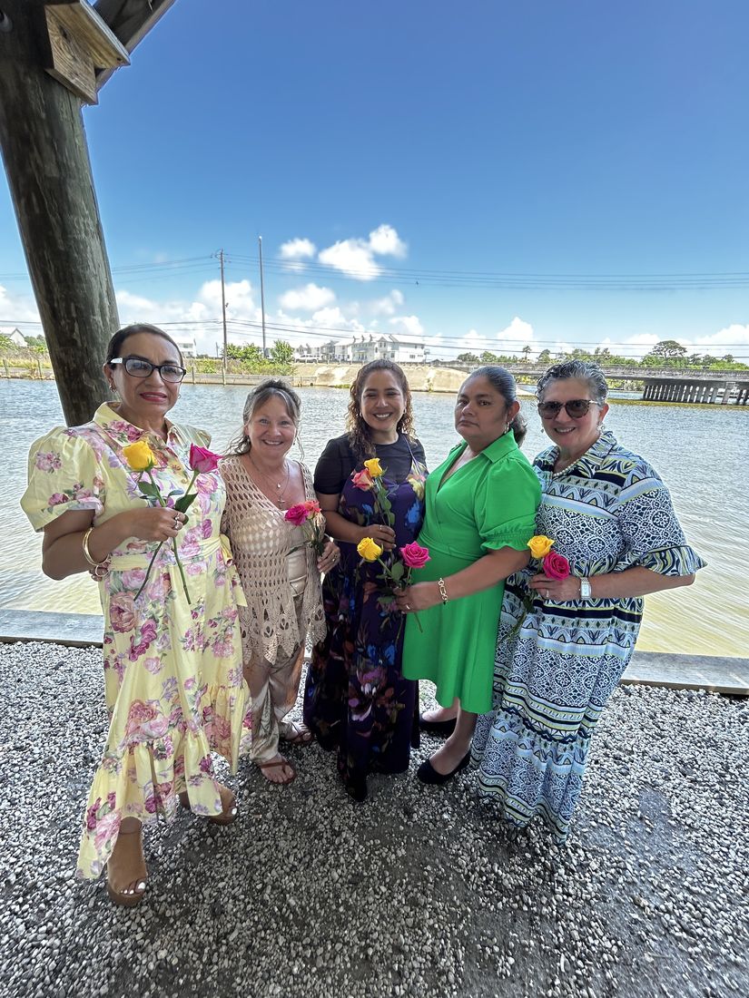 Friends from church standing on the dock by the water