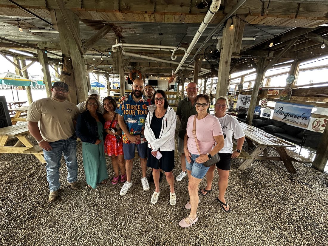 People gathered under the covered deck at Sammy G’s